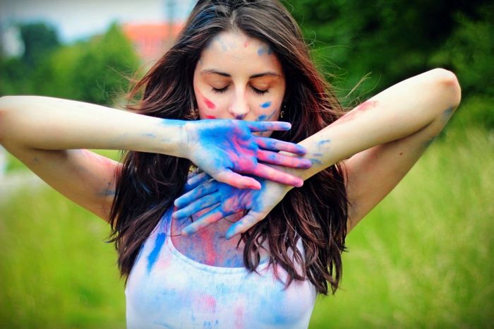 Woman with blue and red body paint covering her face
