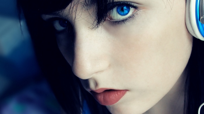 Woman with bright blue eyes wearing headphones