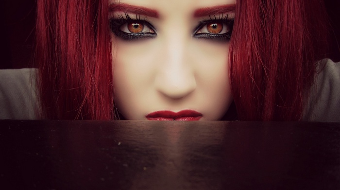 Woman with red hair and red lipstick