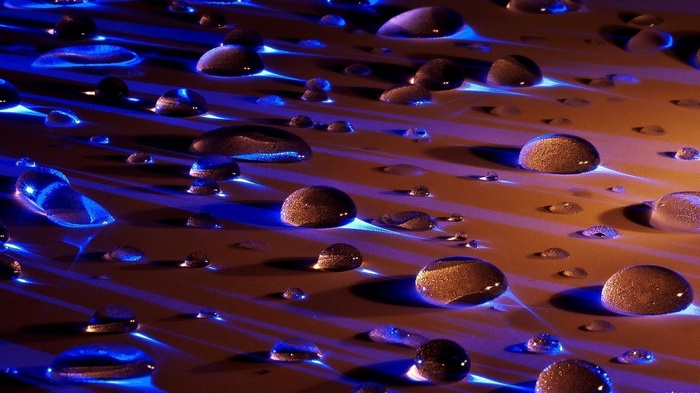 Macro view of water drops with blue and orange light
