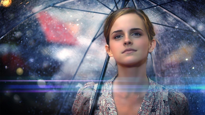Emma Watson under a clear umbrella in the rain