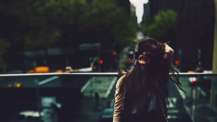 Woman with long hair in a cityscape