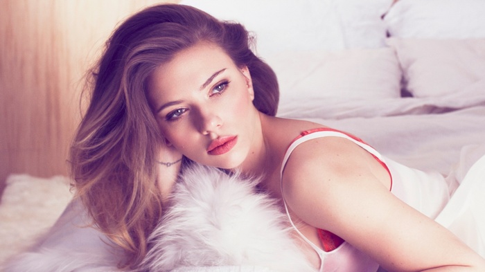 Scarlett Johansson lying in bed wearing lingerie