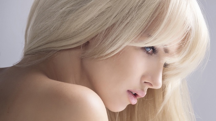 Woman with blonde hair and blue eyes in profile