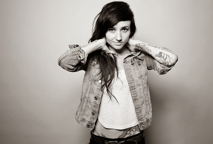 Valerie Poxleitner with tattoos wearing a denim jacket