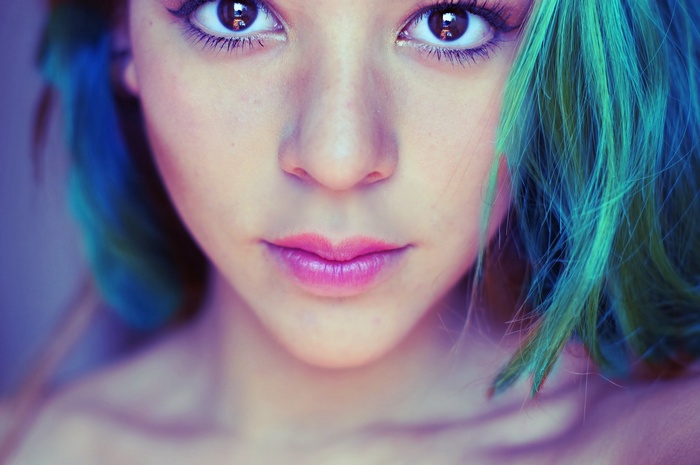 Close-up of a young woman with teal and blue hair