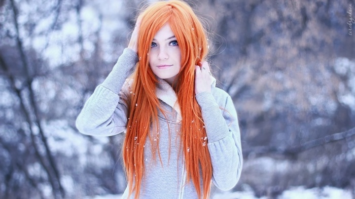 Woman with long orange hair in the snow