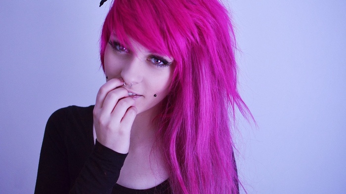 Woman with bright pink hair and piercings