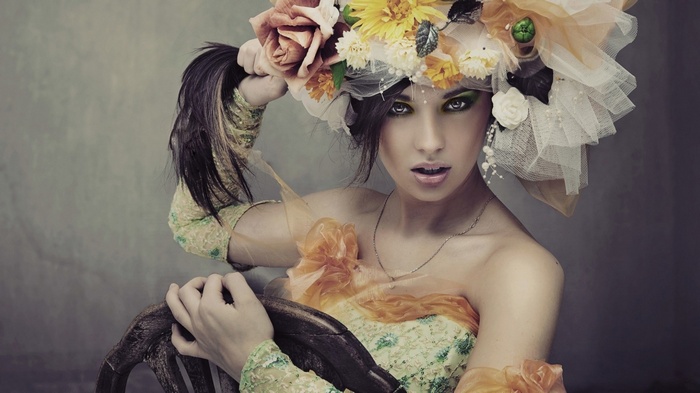 Woman with elaborate floral headdress and yellow eyes