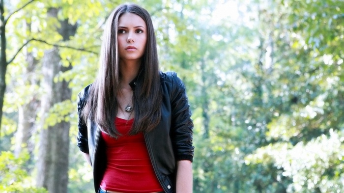Nina Dobrev wearing a red top and leather jacket