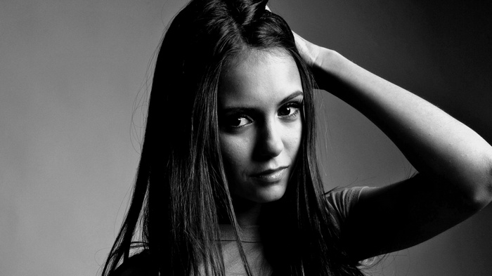 Monochrome portrait of Nina Dobrev with hand in hair