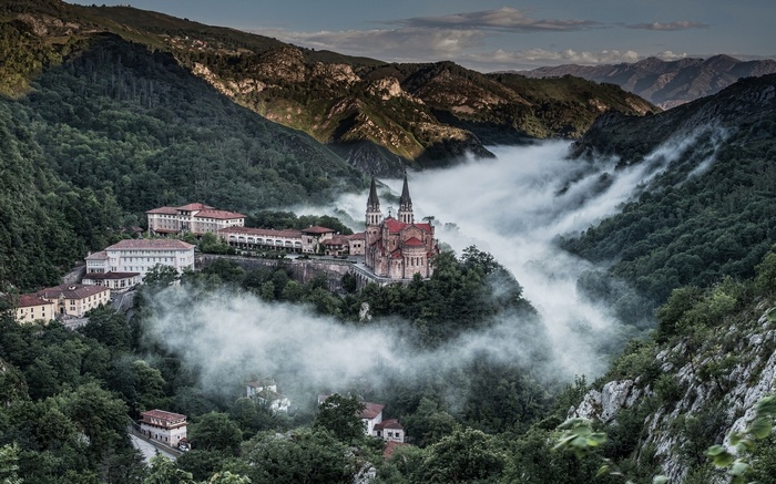 Covadonga Basilica surrounded by mist in a mountain landscape