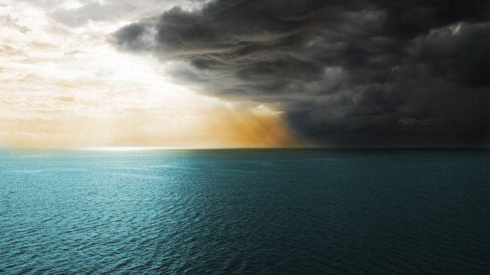 Stormy clouds over the sea with sunlight