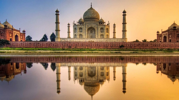 Taj Mahal reflected in the water at sunset
