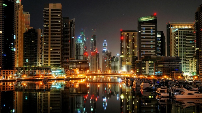 Dubai cityscape with skyscrapers and marina at night