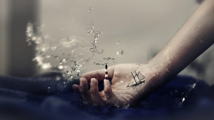Surreal artwork of a hand holding a miniature lighthouse and ship
