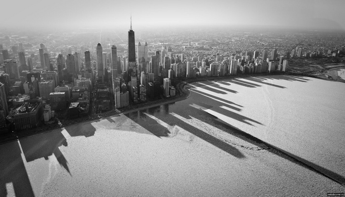 Chicago cityscape with long shadows over Lake Michigan