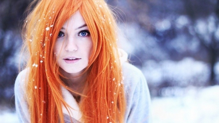 Woman with long orange hair in the snow