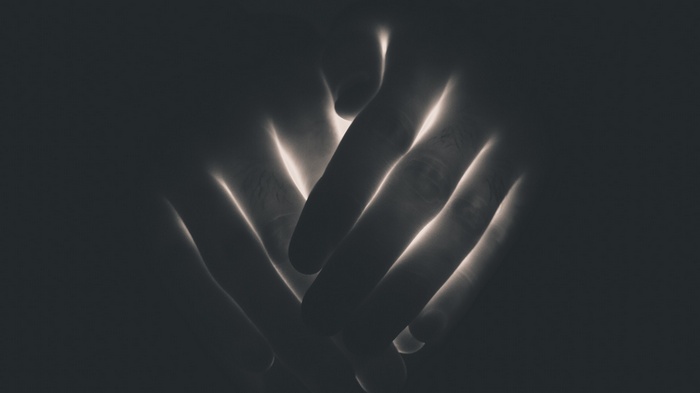 Close-up of hands with dramatic lighting