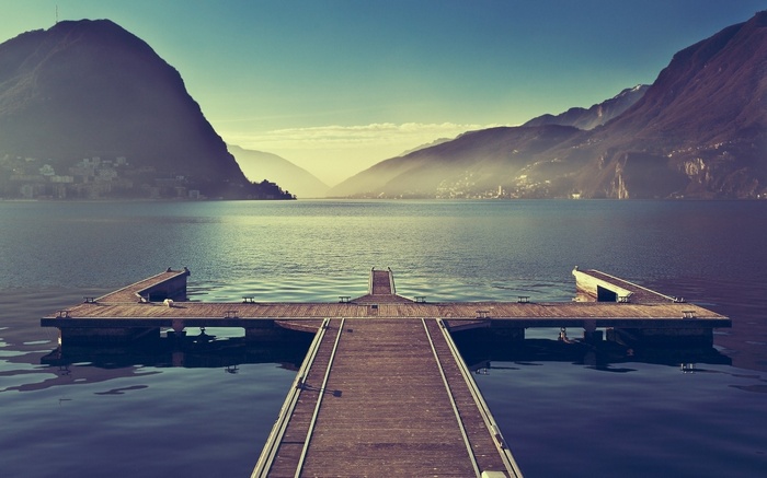 Wooden pier on a lake with mountains