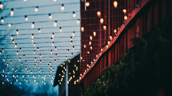 String lights strung across a building at dusk