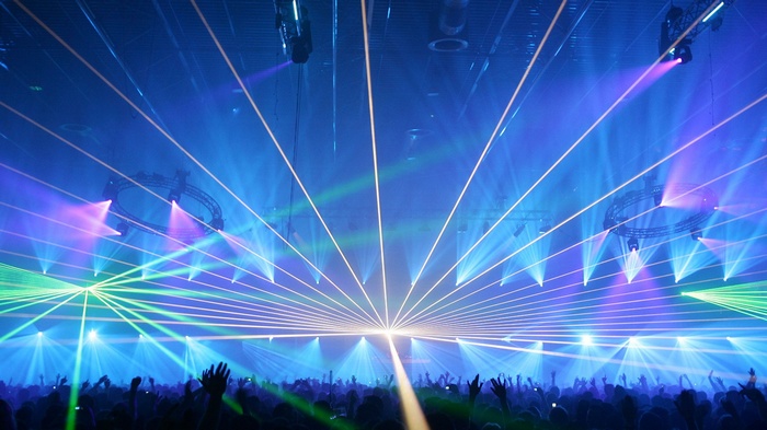Concert crowd with blue and green laser lights