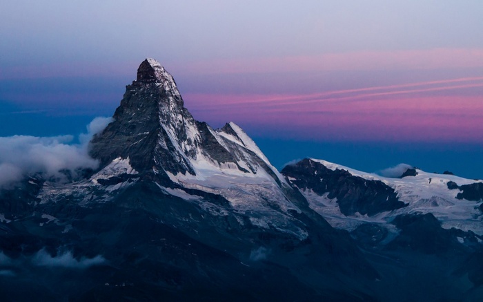 Matterhorn mountain peak at twilight with clouds