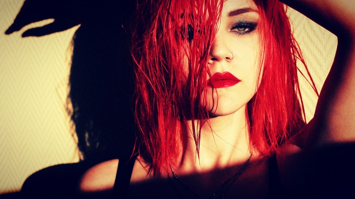 Redhead woman with red lipstick and nose ring