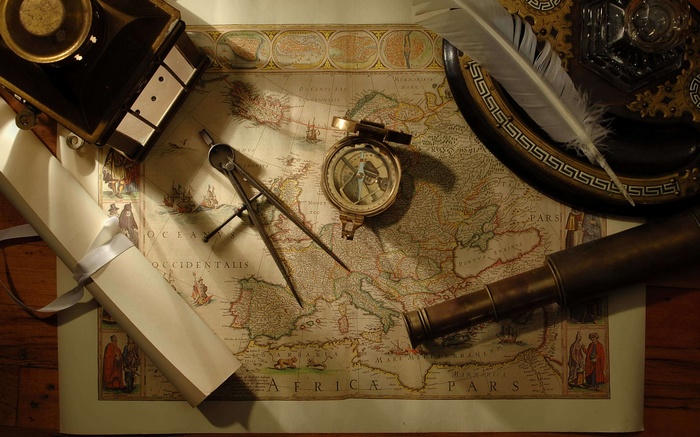 Antique map with compass, telescope, and quill