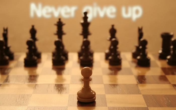 Chess pawn facing black pieces with "Never give up" text