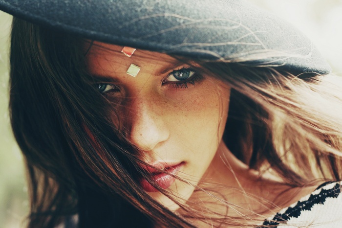 Woman with freckles wearing a hat