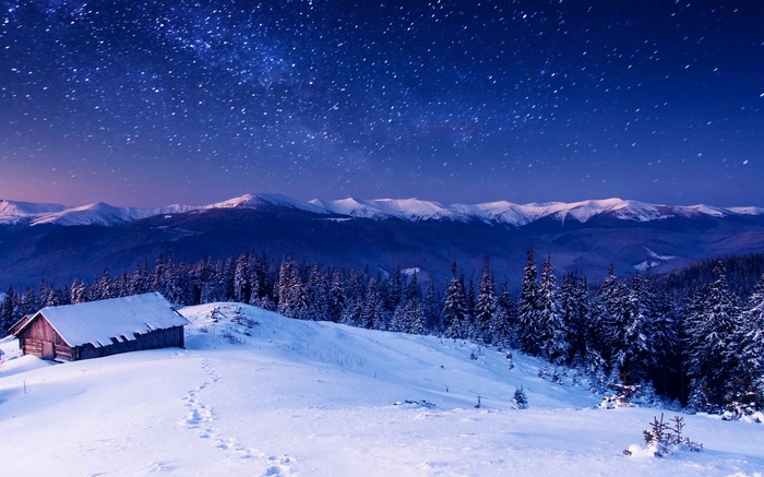 Winter mountains landscape with a cabin under the stars