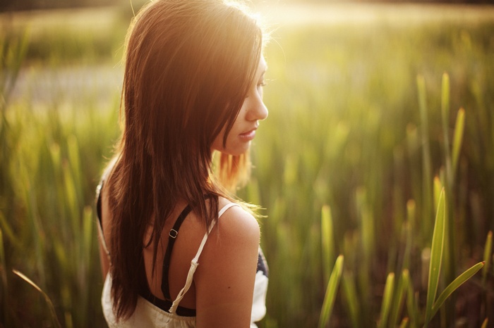 Woman in a field with tall grass