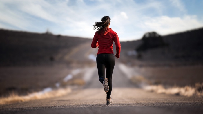 Woman running on a road outdoors