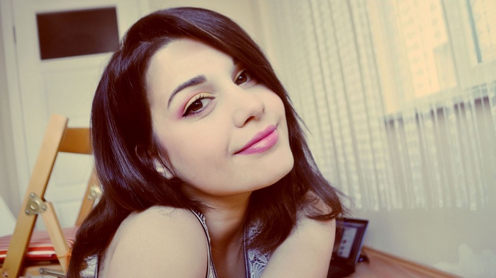 Young woman with makeup smiling