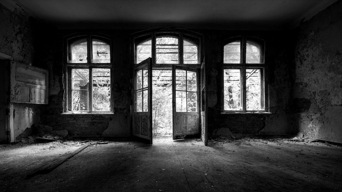 Abandoned room with broken windows and doors