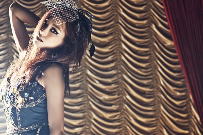 Yoon Bora in a jeweled dress with a feathered headpiece