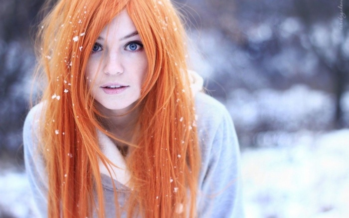 Redhead woman with blue eyes in the snow
