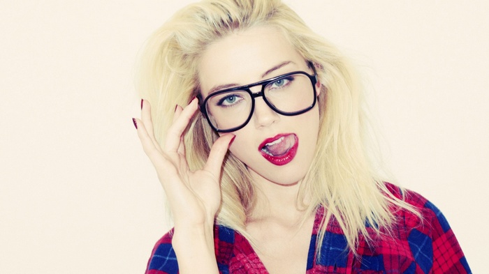 Amber Heard wearing glasses and red plaid shirt