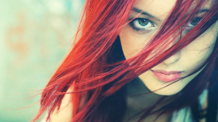 Woman with long red hair and green eyes