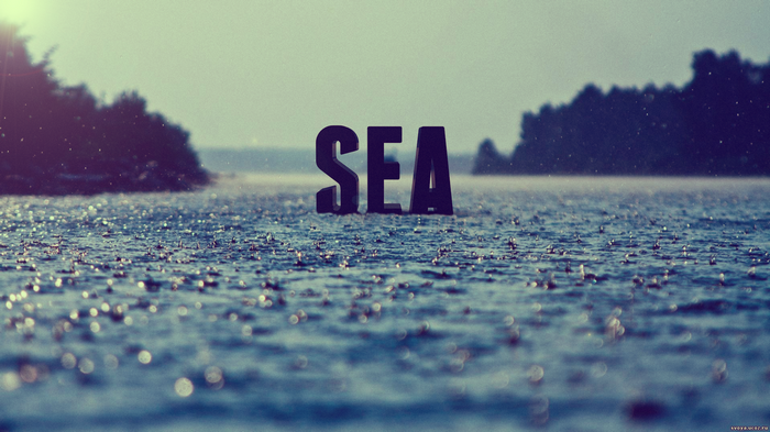 The word SEA in dark 3D typography over a rainy sea