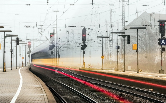 Train station with light trails and overhead wires