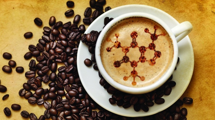 Coffee cup with caffeine molecule art and coffee beans