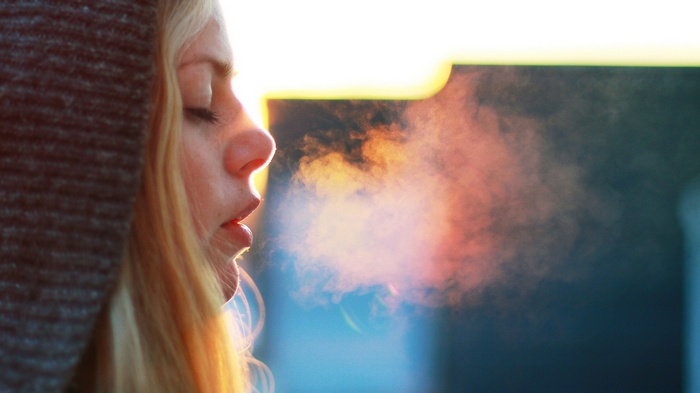Woman exhaling visible breath in the cold