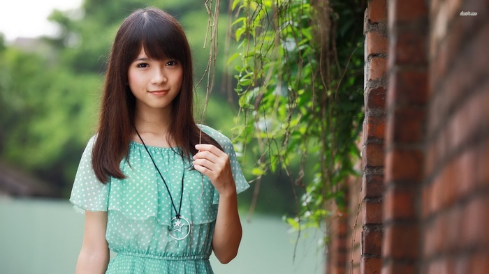 Asian woman in polka dot dress outdoors
