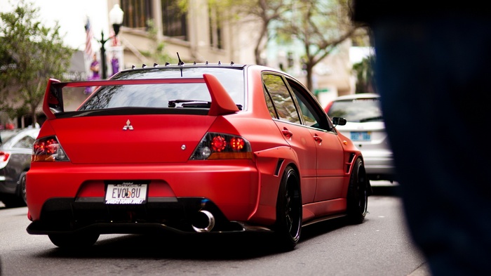Red Mitsubishi Lancer Evolution with custom spoiler