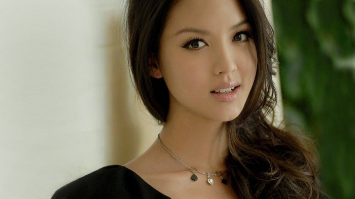 Zhang Zi Lin with wavy brunette hair and dark eyes