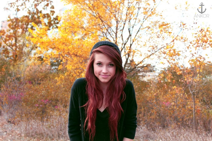 Woman with long red hair and beanie in fall