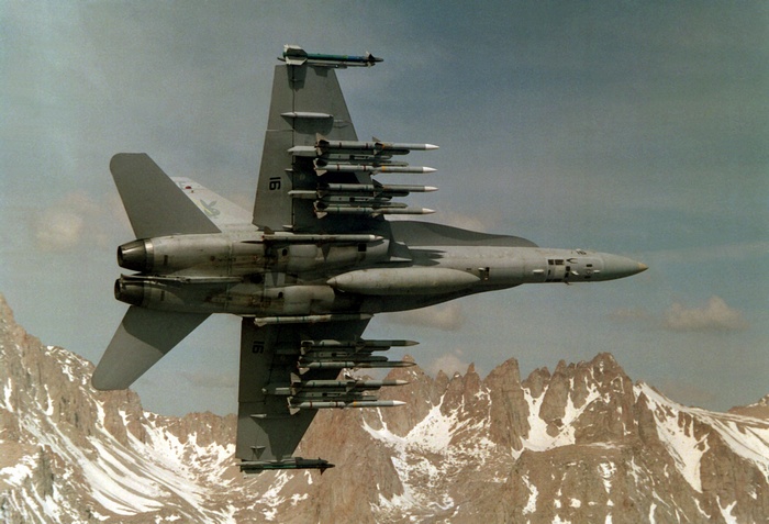 McDonnell Douglas FA-18 Hornet flying over mountains