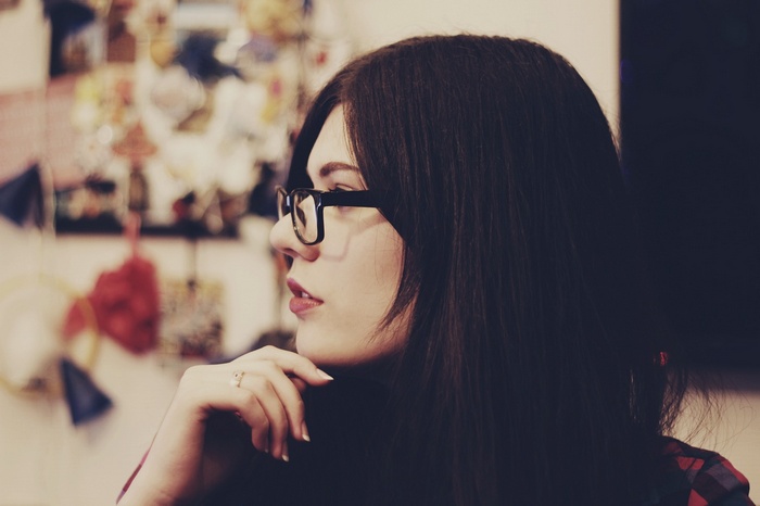 Woman with glasses and dark hair in profile